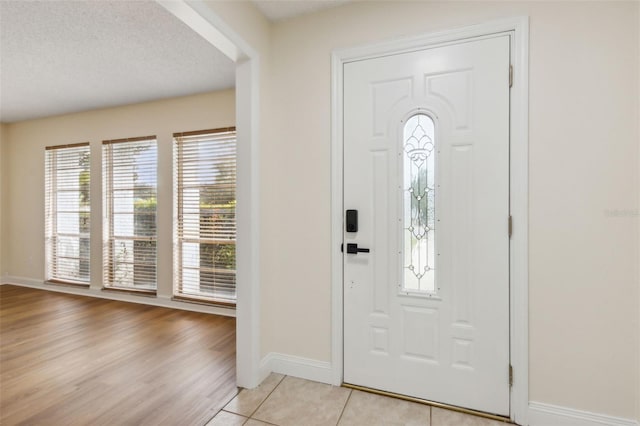 entrance foyer with plenty of natural light and light tile patterned flooring