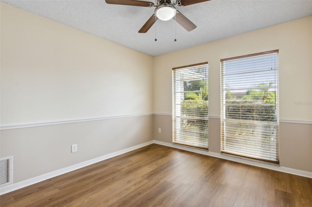 unfurnished room with hardwood / wood-style floors, a textured ceiling, and ceiling fan