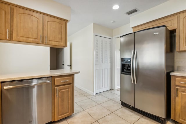 kitchen with stainless steel appliances and light tile patterned flooring