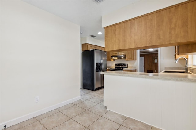 kitchen with sink, light tile patterned floors, and stainless steel appliances