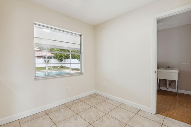 spare room featuring light tile patterned flooring