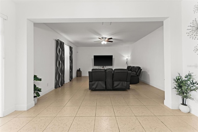 tiled living room with ceiling fan