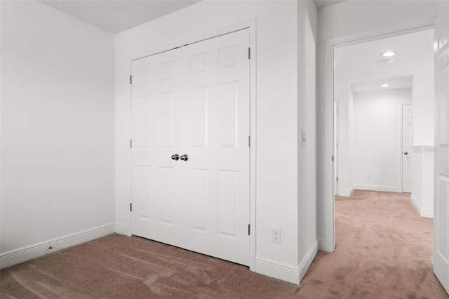 unfurnished bedroom with carpet flooring and a closet