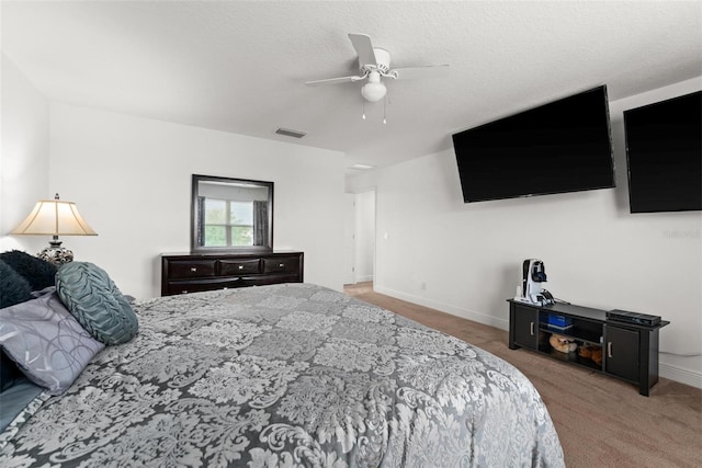 carpeted bedroom with a textured ceiling and ceiling fan