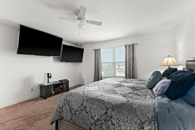 bedroom with ceiling fan, a textured ceiling, and carpet flooring