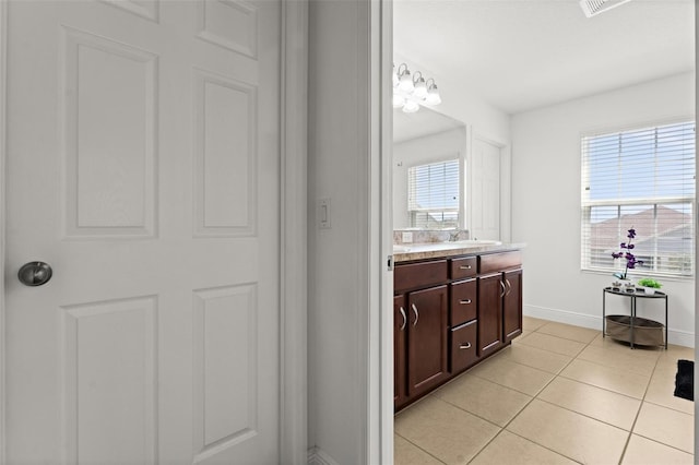 bathroom featuring vanity, a chandelier, and tile patterned flooring