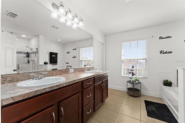 bathroom featuring tile patterned floors, independent shower and bath, and vanity