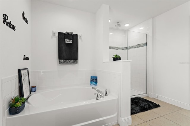 bathroom with independent shower and bath and tile patterned floors