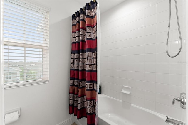 bathroom with shower / bath combination with curtain