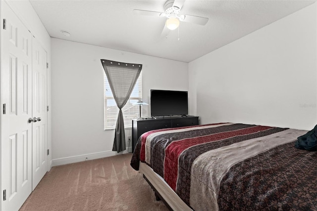 carpeted bedroom with a closet and ceiling fan