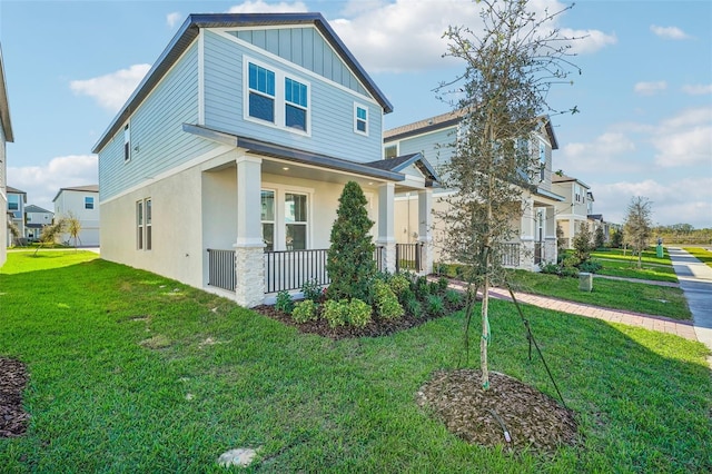 view of front of property with a porch and a front yard