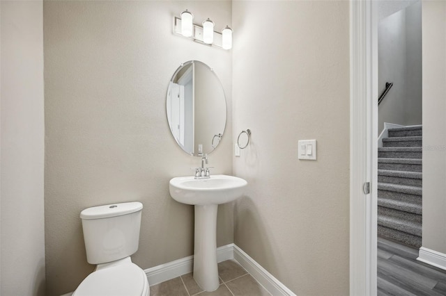 bathroom with tile patterned flooring and toilet