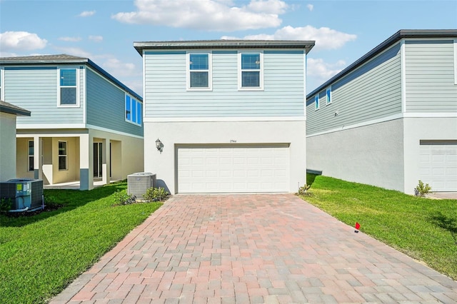 view of front of property with cooling unit, a garage, and a front yard