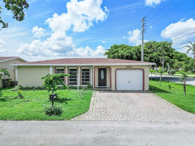 ranch-style house with central AC, a front yard, and a garage