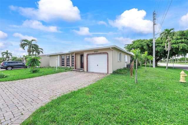 single story home with a front lawn and a garage