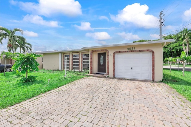 ranch-style home with a garage and a front yard