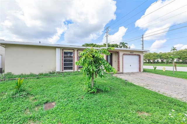 single story home with a front yard and a garage