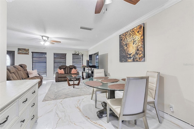 dining area featuring ceiling fan, a textured ceiling, and crown molding