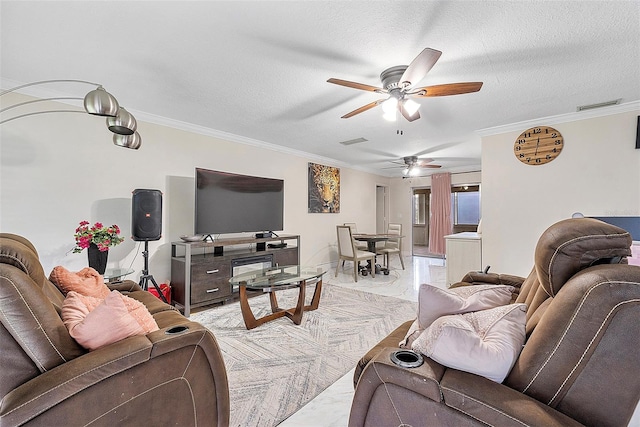 living room with a textured ceiling, crown molding, and ceiling fan