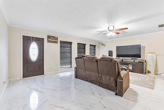 living room with ornamental molding, ceiling fan, and a textured ceiling