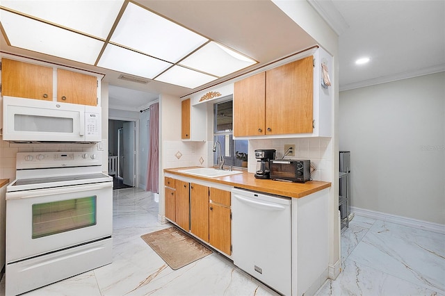 kitchen with white appliances, ornamental molding, sink, and tasteful backsplash