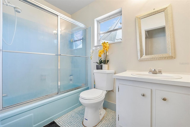 full bathroom featuring tile patterned floors, combined bath / shower with glass door, vanity, and toilet