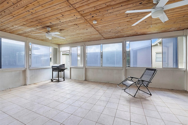 unfurnished sunroom featuring wood ceiling, vaulted ceiling, and ceiling fan