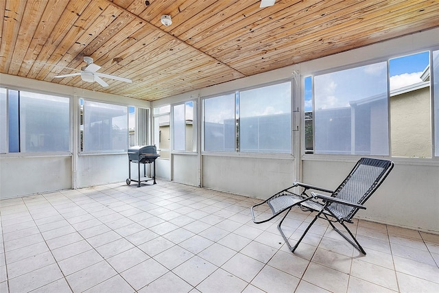 unfurnished sunroom with ceiling fan and wooden ceiling