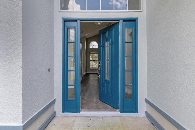 property entrance with stucco siding