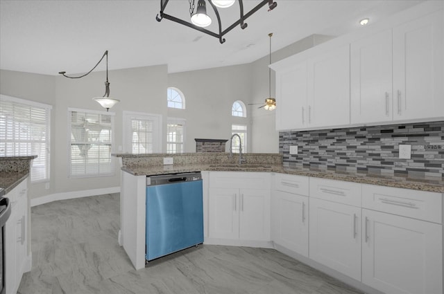 kitchen with pendant lighting, sink, white cabinets, kitchen peninsula, and appliances with stainless steel finishes