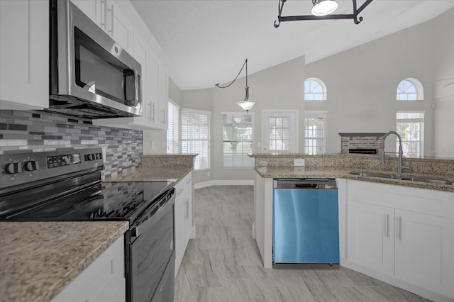 kitchen featuring a sink, stainless steel microwave, vaulted ceiling, black electric range oven, and dishwasher
