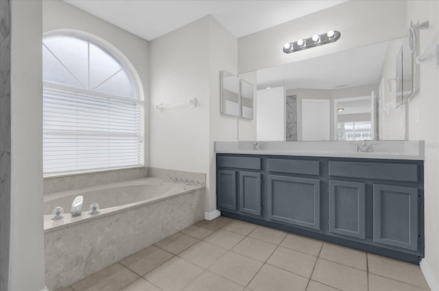 bathroom featuring a bath, tile patterned floors, a sink, and double vanity