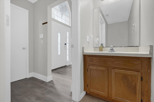 bathroom with vanity and hardwood / wood-style flooring