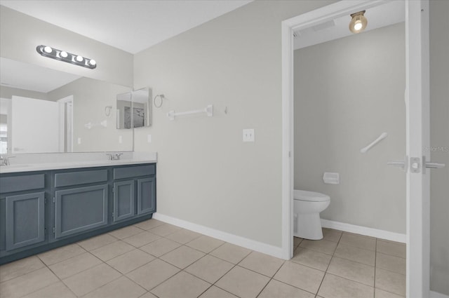 full bath with a sink, double vanity, toilet, baseboards, and tile patterned flooring
