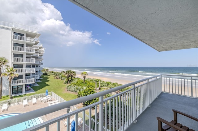 balcony with a view of the beach and a water view