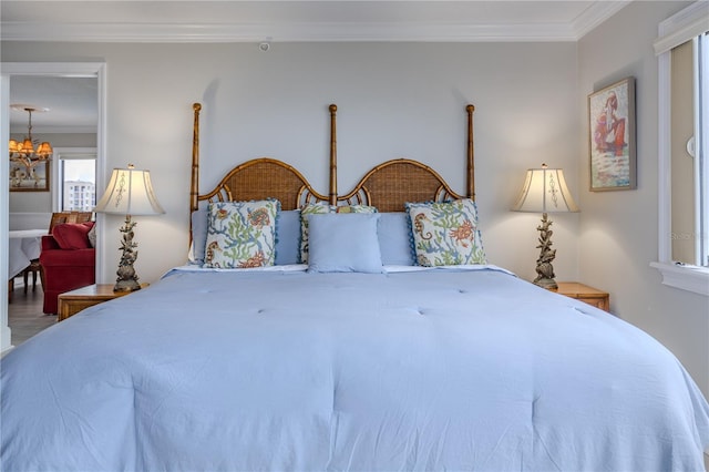 bedroom with an inviting chandelier, hardwood / wood-style floors, and crown molding