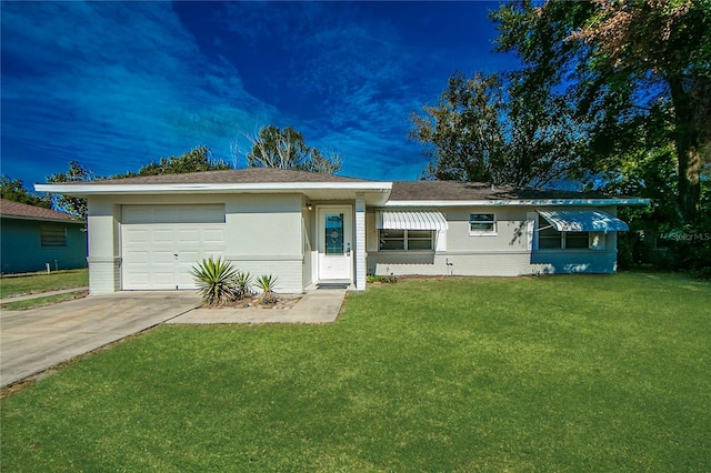 view of front of house with a front yard and a garage