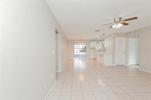 unfurnished living room featuring light tile patterned floors and ceiling fan with notable chandelier