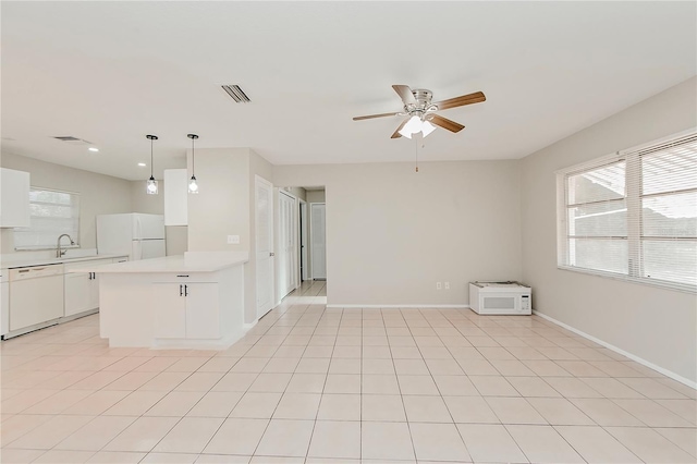 kitchen with white appliances, ceiling fan, pendant lighting, light tile patterned floors, and white cabinets