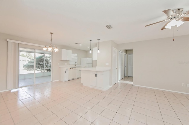 kitchen featuring white appliances, white cabinets, ceiling fan with notable chandelier, sink, and decorative light fixtures