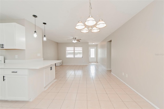 kitchen with decorative light fixtures, white cabinets, light tile patterned flooring, and ceiling fan with notable chandelier