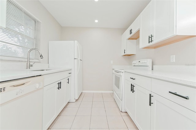 kitchen featuring white cabinetry, light tile patterned flooring, white appliances, and sink