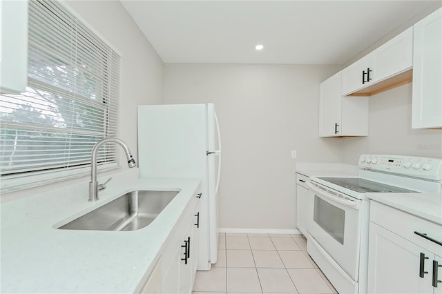 kitchen with white range with electric stovetop, light tile patterned flooring, white cabinetry, and sink