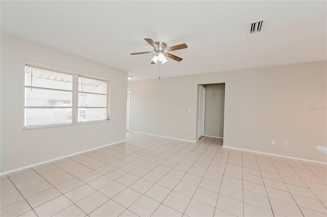 tiled empty room with ceiling fan