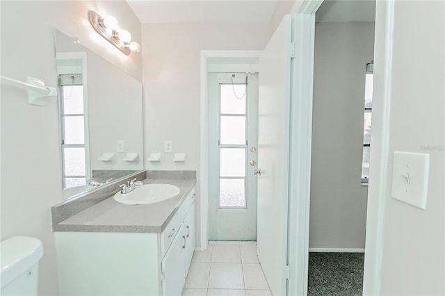 bathroom featuring toilet, vanity, and tile patterned floors