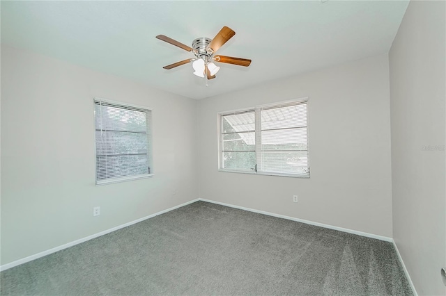 carpeted spare room with ceiling fan