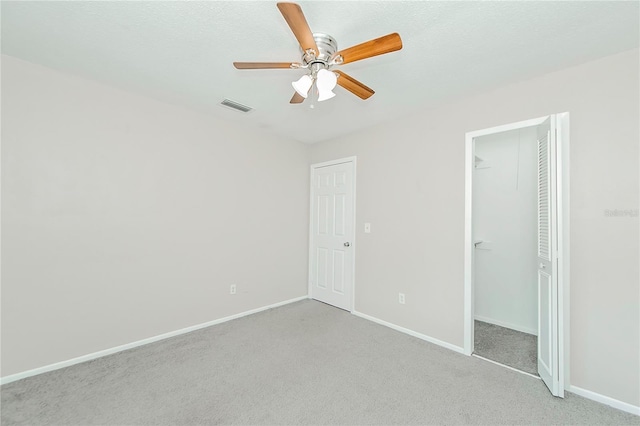 unfurnished bedroom with ceiling fan and light colored carpet