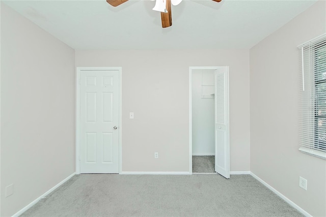 unfurnished bedroom with ceiling fan and light carpet