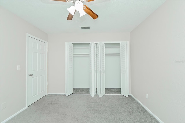 unfurnished bedroom with ceiling fan and light carpet