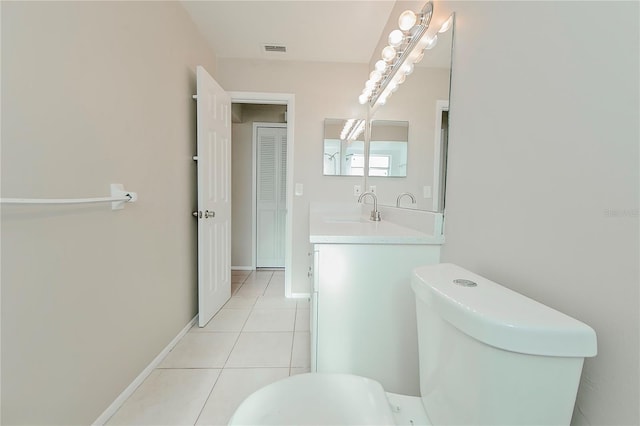 bathroom featuring tile patterned flooring, vanity, and toilet